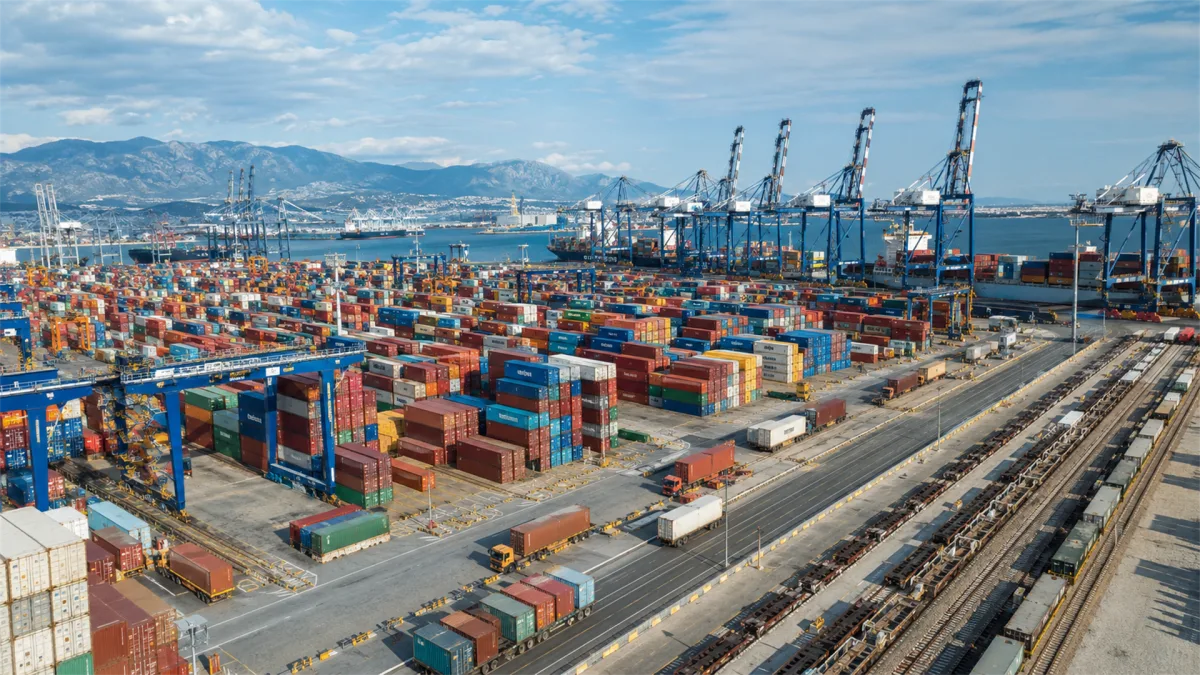 aerial container port with cranes cargo stacks and coastline