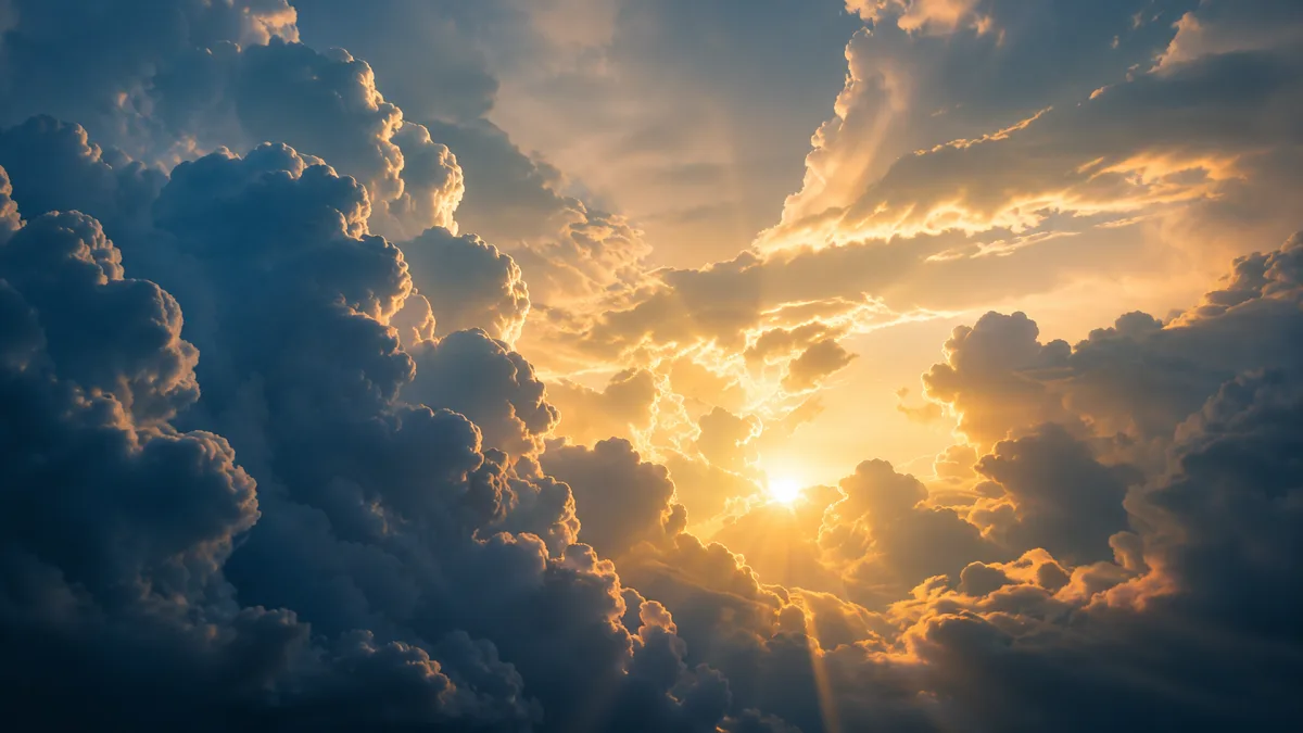 sunbeams breaking through towering blue and gold clouds